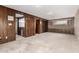Bedroom featuring carpet, wood paneling and a brick accent wall at 27002 N 64Th St, Scottsdale, AZ 85266