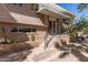 Inviting entrance with decorative metal railing and brick accents, leading to the front door at 27002 N 64Th St, Scottsdale, AZ 85266