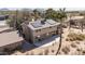 Two-story home with desert landscaping, solar panels, and an outdoor seating area at 27002 N 64Th St, Scottsdale, AZ 85266