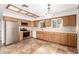 Bright kitchen featuring stainless steel appliances, wood cabinets, and a large window at 27002 N 64Th St, Scottsdale, AZ 85266