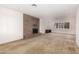 Cozy living room features a classic brick fireplace and large windows at 27002 N 64Th St, Scottsdale, AZ 85266