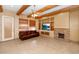 Inviting living room featuring exposed beams, tile floors, a stone fireplace and built-in shelves at 28619 N 152Nd St, Scottsdale, AZ 85262