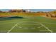 Well-maintained basketball court with clear markings, set against a backdrop of green space and community buildings at 29243 N 122Nd Ln, Peoria, AZ 85383