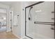 Modern bathroom featuring a glass-enclosed shower with bronze hardware and tiled floor at 29243 N 122Nd Ln, Peoria, AZ 85383