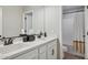 Bright bathroom featuring a double sink vanity with bronze fixtures, and shower with tub combination at 29243 N 122Nd Ln, Peoria, AZ 85383
