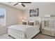 Stylish bedroom featuring a luxurious bed, mirrored dresser, and modern decor accents at 29243 N 122Nd Ln, Peoria, AZ 85383