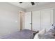Bedroom featuring a closet with sliding doors, light walls, and an open door at 29243 N 122Nd Ln, Peoria, AZ 85383
