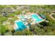 Aerial view of the community pool complex with multiple pools, cabanas, lounge chairs, and lush landscaping at 29243 N 122Nd Ln, Peoria, AZ 85383
