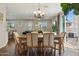 Bright dining area features wood floors and a stylish chandelier with backyard views at 29243 N 122Nd Ln, Peoria, AZ 85383