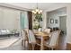 Inviting dining room with a chandelier, table set for six, and sliding glass doors leading to an outdoor patio at 29243 N 122Nd Ln, Peoria, AZ 85383