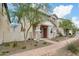 Welcoming home exterior with stone pillars, a well-maintained walkway, and mature landscaping at 29243 N 122Nd Ln, Peoria, AZ 85383
