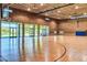 Spacious gymnasium featuring hardwood floors, basketball hoops, large windows, and ample natural light at 29243 N 122Nd Ln, Peoria, AZ 85383