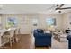 Spacious living area featuring a sofa, wood floors, and large windows offering natural light and outdoor views at 29243 N 122Nd Ln, Peoria, AZ 85383