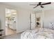 Spacious main bedroom features a ceiling fan and ensuite bath and adjoining room at 29243 N 122Nd Ln, Peoria, AZ 85383