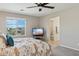 Bright main bedroom features a large window and TV at 29243 N 122Nd Ln, Peoria, AZ 85383