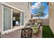 Outdoor patio with a grill, umbrella, and seating with an open sliding glass door to the living room at 29243 N 122Nd Ln, Peoria, AZ 85383