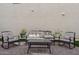 Comfortable outdoor seating area with a sofa, chairs, a table, and decorative plants at 29243 N 122Nd Ln, Peoria, AZ 85383