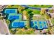 Aerial view of tennis and pickleball courts surrounded by trees, offering recreational opportunities within the community at 29243 N 122Nd Ln, Peoria, AZ 85383