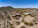 Expansive desert property with a luxury home, equestrian arena, and mountain views under a clear sky at 31912 N 141St St, Scottsdale, AZ 85262