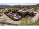 Aerial view of the custom home featuring a pool, landscaped courtyard, and architectural design at 31912 N 141St St, Scottsdale, AZ 85262