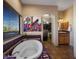 Bright bathroom features a soaking tub, large window, and walk-in closet at 31912 N 141St St, Scottsdale, AZ 85262