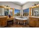 Bathroom features dual vanities, a clawfoot tub, and beautiful views at 31912 N 141St St, Scottsdale, AZ 85262
