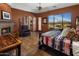 Comfortable bedroom featuring fireplace, an exterior door and expansive views at 31912 N 141St St, Scottsdale, AZ 85262