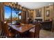 Elegant dining room with a modern chandelier, fireplace, and panoramic views at 31912 N 141St St, Scottsdale, AZ 85262