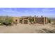 Exterior view of a luxurious estate with desert landscaping and mountain views at 31912 N 141St St, Scottsdale, AZ 85262