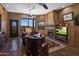 Cozy living room featuring a fireplace, comfortable seating, and large windows with scenic views at 31912 N 141St St, Scottsdale, AZ 85262