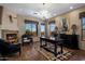 Elegant living room with fireplace, chandelier, and views of the outdoors at 31912 N 141St St, Scottsdale, AZ 85262