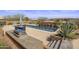 Gorgeous pool area with outdoor kitchen, landscaping, and dining area at 31912 N 141St St, Scottsdale, AZ 85262