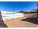 Spacious gravel backyard featuring a white fence and block wall, ideal for outdoor activities at 346 S Florence St, Casa Grande, AZ 85122