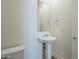 Chic powder room features a pedestal sink and modern fixtures at 35231 N Danburite Ct, San Tan Valley, AZ 85144