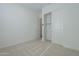 Well-lit bedroom boasts plush carpeting and ample closet space with slider doors at 35231 N Danburite Ct, San Tan Valley, AZ 85144