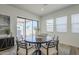 Bright dining area featuring a round table, stylish chairs, and access to the patio at 35231 N Danburite Ct, San Tan Valley, AZ 85144