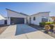 Contemporary home featuring desert landscaping, a gray garage door, and a light-colored facade at 35231 N Danburite Ct, San Tan Valley, AZ 85144