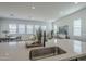 Open-concept kitchen with island sink and views of dining and living areas filled with natural light at 35231 N Danburite Ct, San Tan Valley, AZ 85144