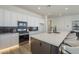 Bright kitchen boasts stainless steel appliances, white cabinets, and a large island with bar seating at 35231 N Danburite Ct, San Tan Valley, AZ 85144