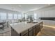 Kitchen island with quartz countertops, stainless steel sink, and views of the living room at 35231 N Danburite Ct, San Tan Valley, AZ 85144