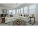 Bright living room featuring a comfortable sectional sofa and stylish round coffee table at 35231 N Danburite Ct, San Tan Valley, AZ 85144