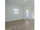 Open living area showcases wood-look flooring and bright, airy space at 35231 N Danburite Ct, San Tan Valley, AZ 85144