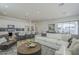 Open concept living space featuring living, dining, and kitchen areas in a modern design at 35231 N Danburite Ct, San Tan Valley, AZ 85144
