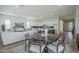 Open-concept living space combining dining, kitchen, and living room areas at 35231 N Danburite Ct, San Tan Valley, AZ 85144