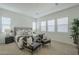 Relaxing main bedroom with neutral colors, seating area, and large windows allowing ample light at 35231 N Danburite Ct, San Tan Valley, AZ 85144