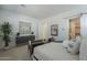 Comfortable main bedroom boasts neutral colors and large windows with a view of ensuite bathroom and storage at 35231 N Danburite Ct, San Tan Valley, AZ 85144