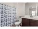 Bathroom showcases a vanity sink, white toilet, and a shower with a patterned blue curtain at 375 S Soledad Ln, Casa Grande, AZ 85194