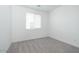 Bright bedroom with neutral carpeting and a window at 40234 N Alegre Dr, San Tan Valley, AZ 85140