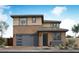 Contemporary two-story home featuring a neutral color scheme, an attached garage, and manicured desert landscaping at 40234 N Alegre Dr, San Tan Valley, AZ 85140