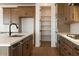 Open kitchen with pantry, stainless steel appliances, and quartz countertops at 40234 N Alegre Dr, San Tan Valley, AZ 85140
